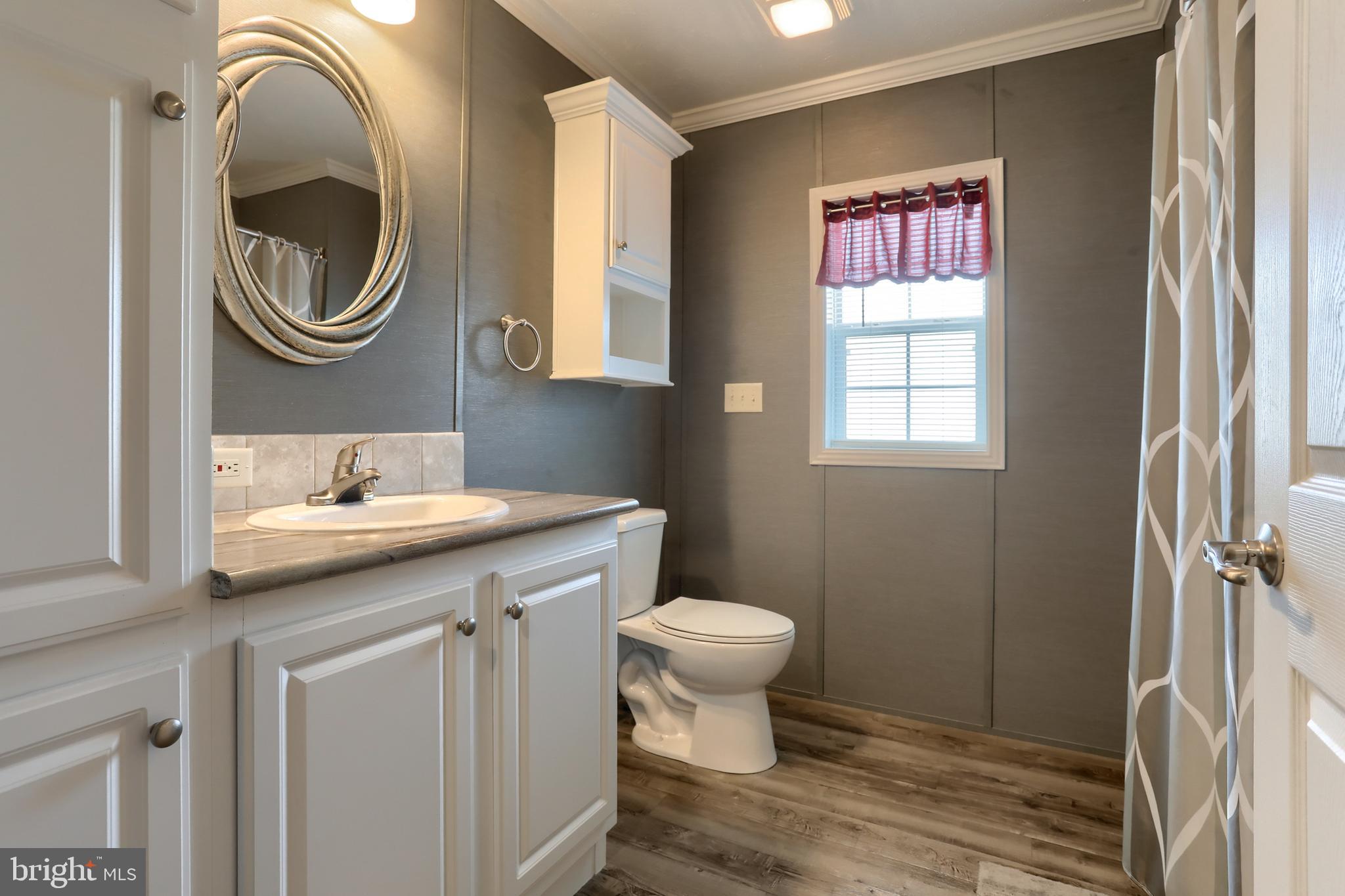 1300 East Kercher Avenue, Unit 32 Myerstown, PA 17067 - Photo 15 of 27 a bathroom with a toilet a sink and a mirror