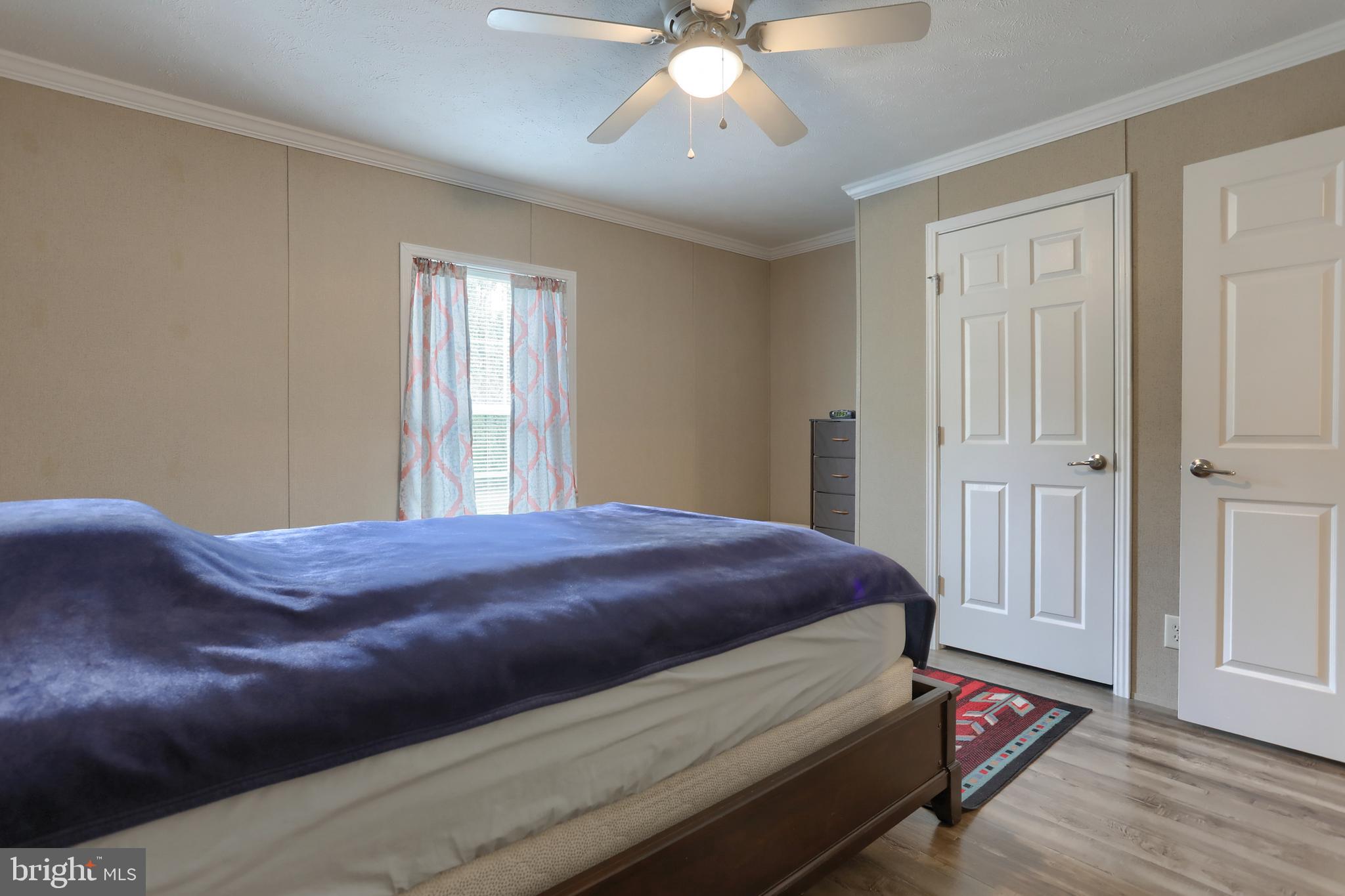 1300 East Kercher Avenue, Unit 32 Myerstown, PA 17067 - Photo 17 of 27 a bedroom with a bed and a chandelier