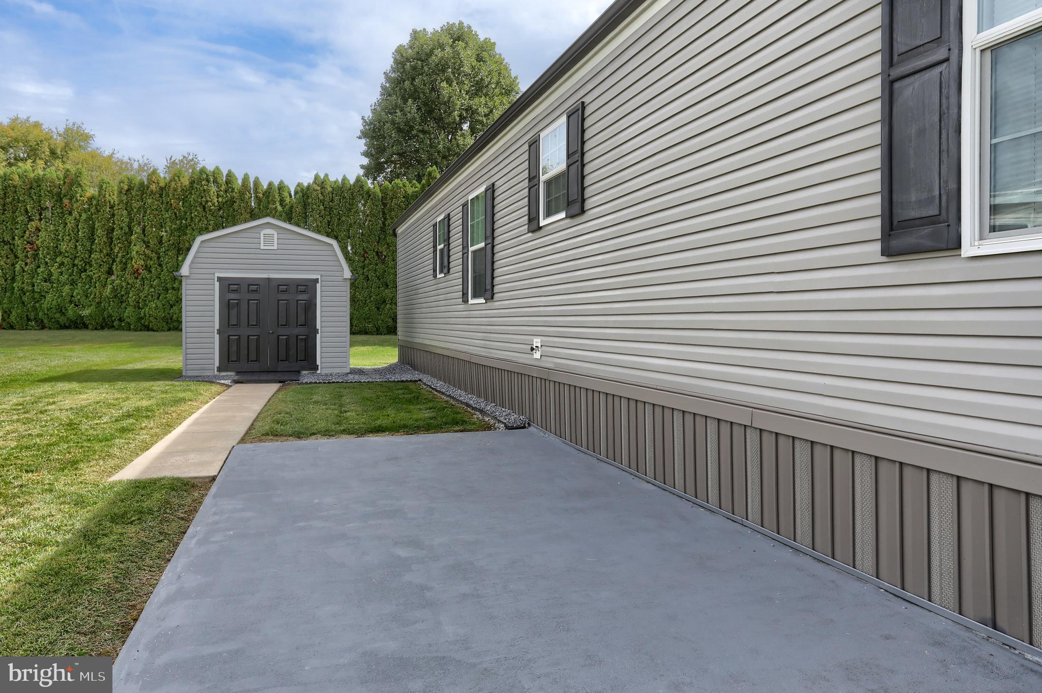 1300 East Kercher Avenue, Unit 32 Myerstown, PA 17067 - Photo 25 of 27 a view of a house with a yard and a large tree
