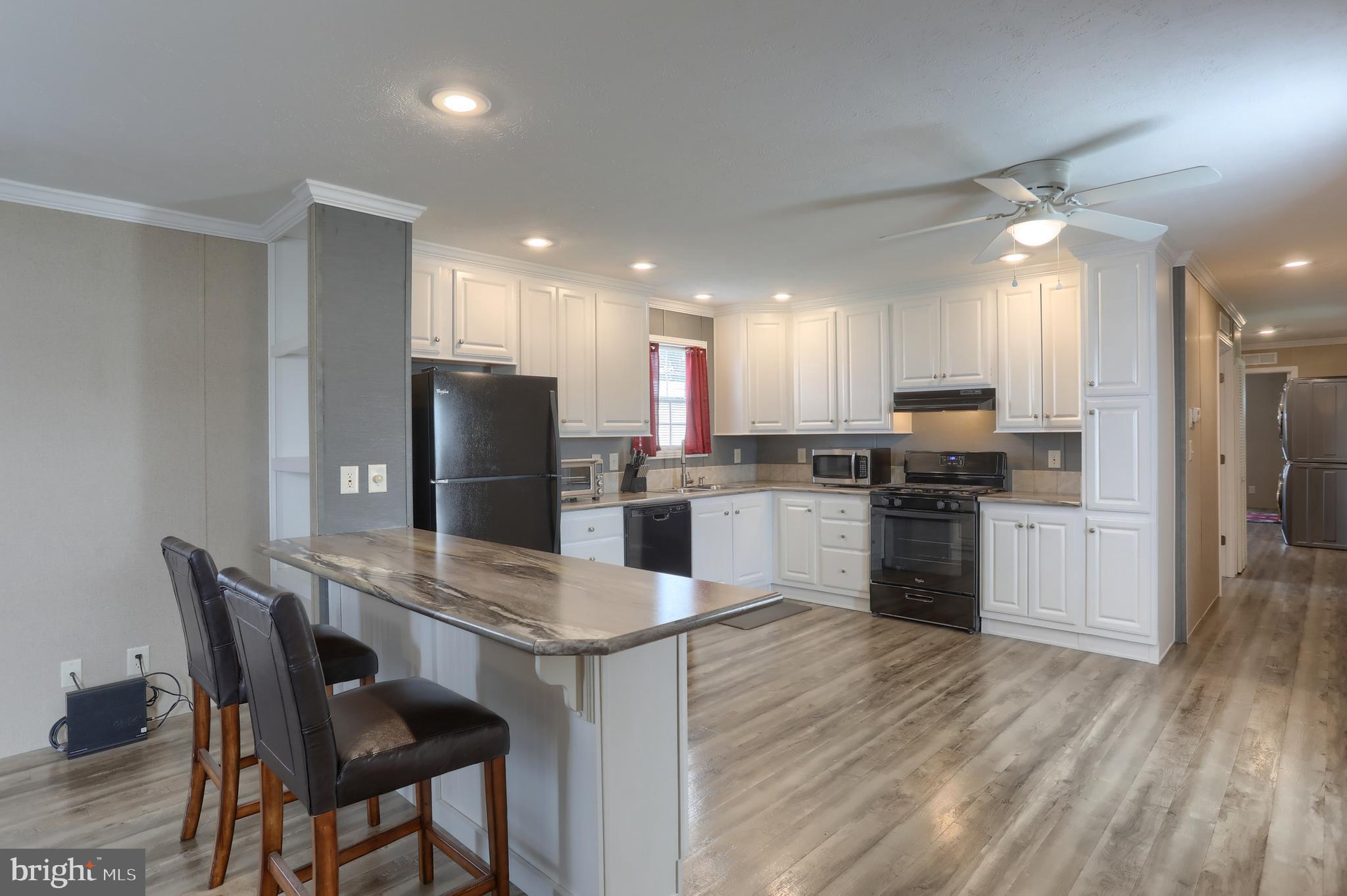 1300 East Kercher Avenue, Unit 32 Myerstown, PA 17067 - Photo 7 of 27 a kitchen with refrigerator and chairs