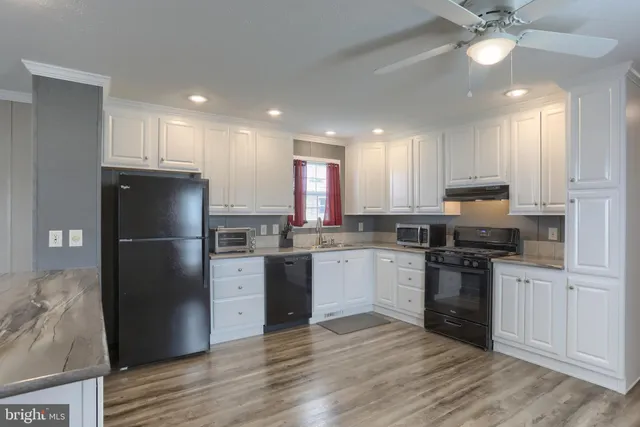 a kitchen with a refrigerator stove top oven and sink