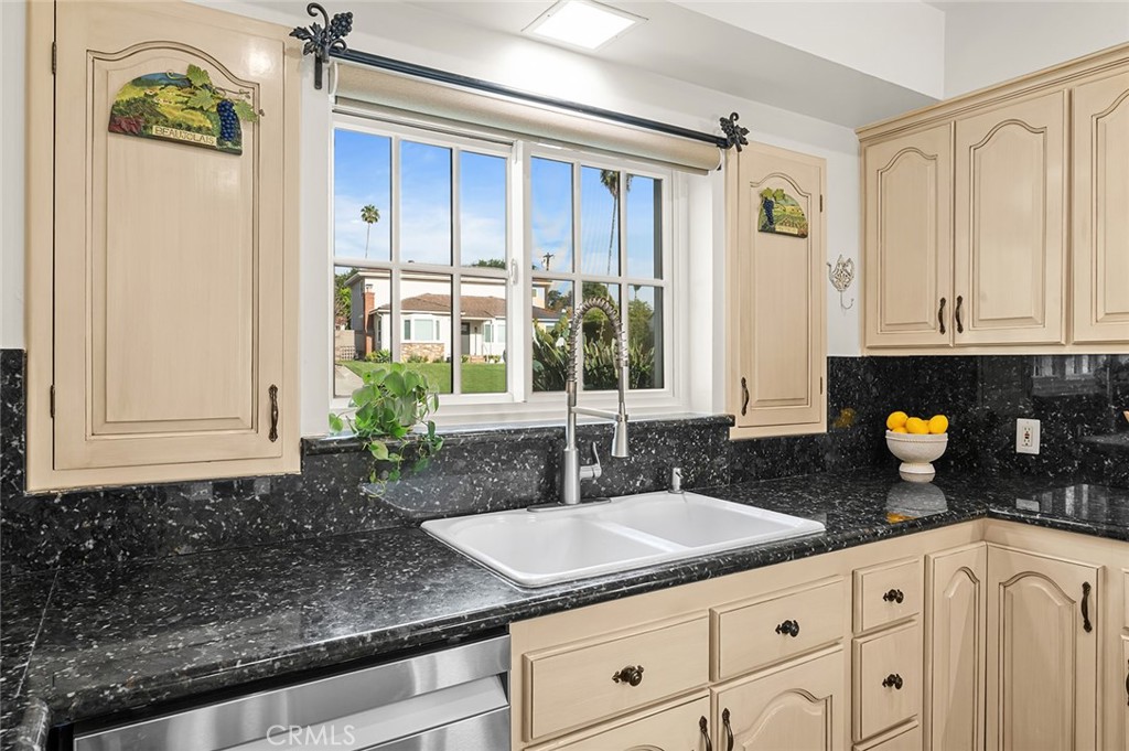 5487 Cadbury Road Whittier, CA 90601 - Photo 16 of 73 a kitchen with granite countertop a sink a stove and cabinets