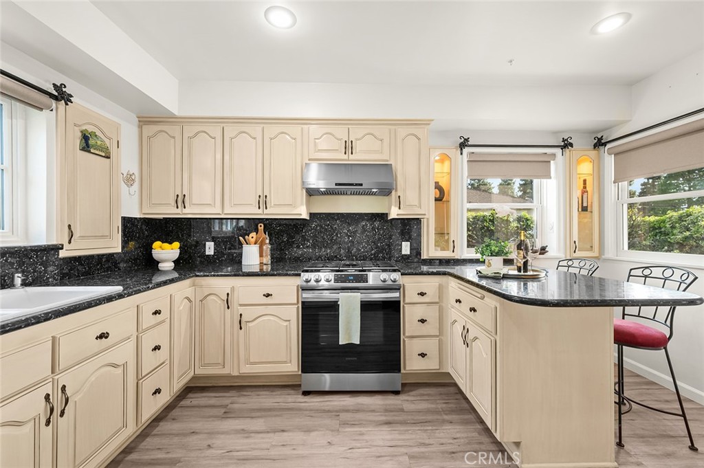 5487 Cadbury Road Whittier, CA 90601 - Photo 17 of 73 a large kitchen with stainless steel appliances granite countertop a stove and cabinets