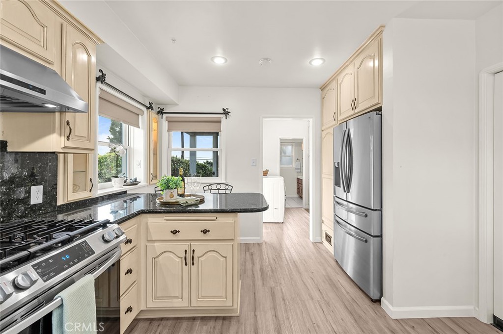 5487 Cadbury Road Whittier, CA 90601 - Photo 18 of 73 a kitchen with stainless steel appliances a refrigerator a stove a sink and white cabinets