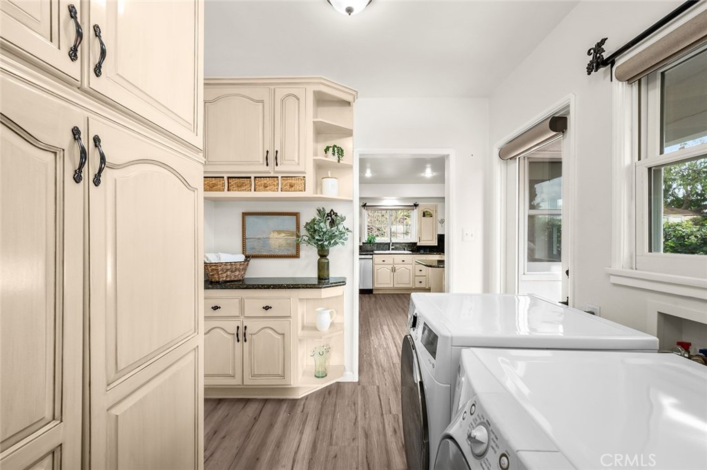 5487 Cadbury Road Whittier, CA 90601 - Photo 21 of 73 a kitchen with stainless steel appliances a stove a sink and a refrigerator with wooden floor