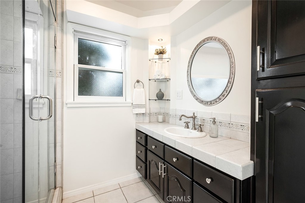 5487 Cadbury Road Whittier, CA 90601 - Photo 22 of 73 a bathroom with a double vanity sink and a mirror