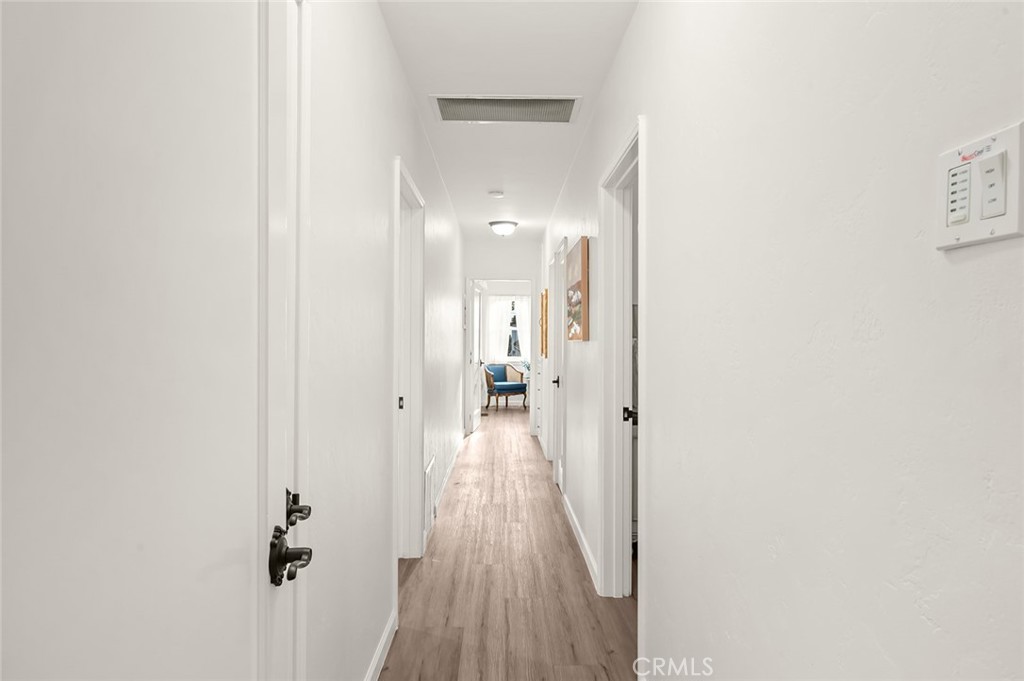 5487 Cadbury Road Whittier, CA 90601 - Photo 29 of 73 a view of a hallway with wooden floor and a bathroom