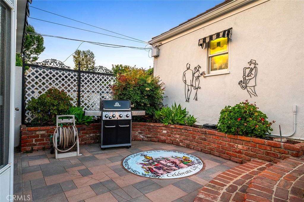 5487 Cadbury Road Whittier, CA 90601 - Photo 56 of 73 a view of a patio with table and chairs potted plants