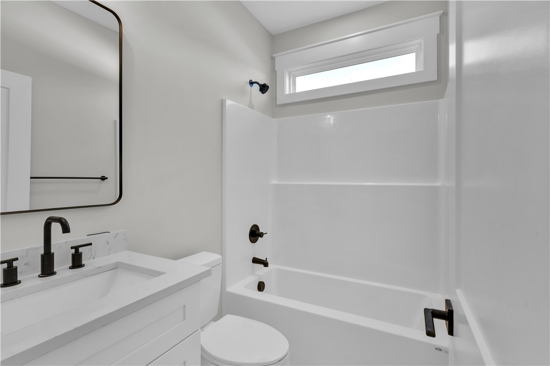 516 Lakeside Drive Anderson, SC 29621 - Photo 13 of 32 A well-appointed bathroom features a sleek vanity and a tub-shower combination.