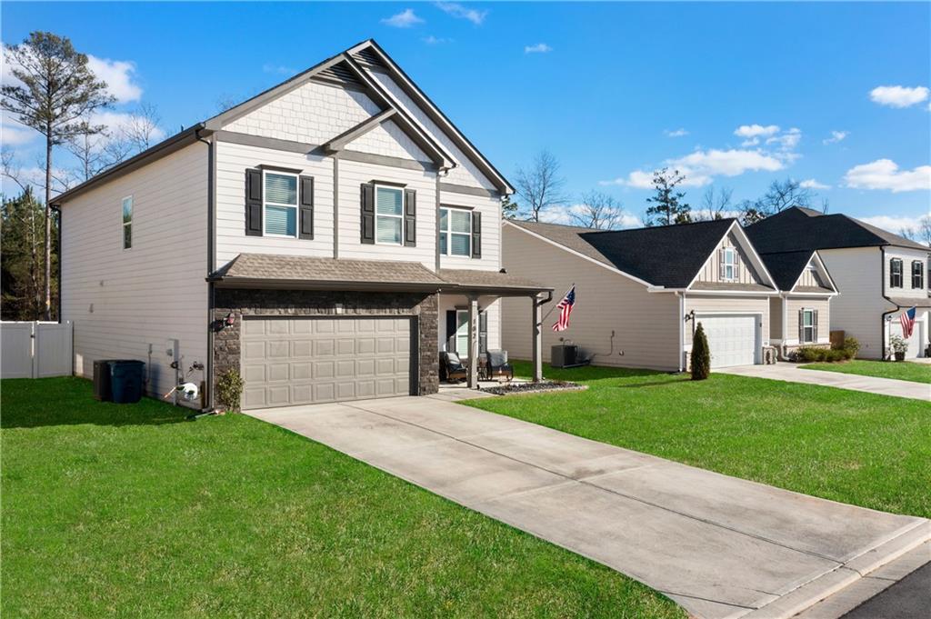 102 Royal Oak Drive Northeast Rome, GA 30165 - Photo 2 of 41 a front view of a house with a yard and garage