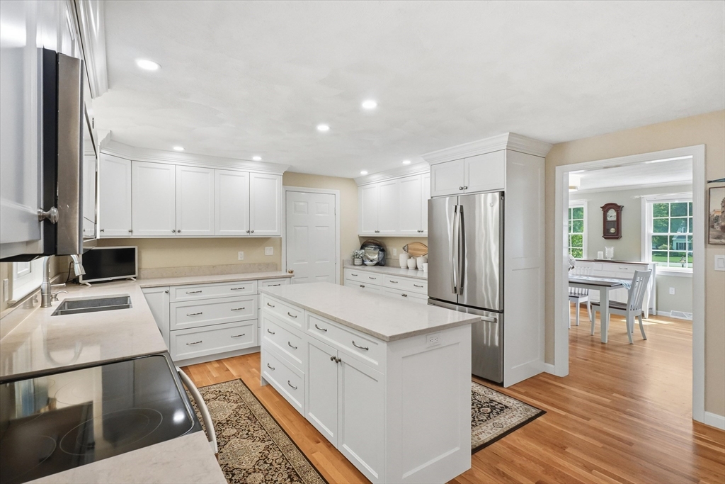 9 Fazio Farm Road Georgetown, MA 01833 - Photo 10 of 42 a kitchen with white cabinets and stainless steel appliances