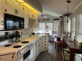 a kitchen with stainless steel appliances a sink stove and cabinets