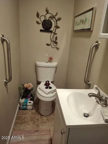 a bathroom with a sink toilet and a mirror