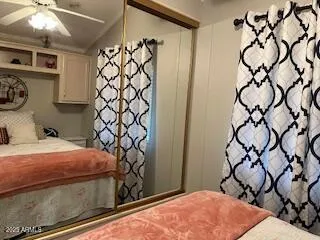 a bedroom with a bed and a mirror