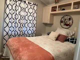 a bedroom with a bed and a window