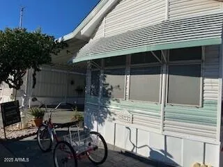 a patio with table and chairs and potted plants