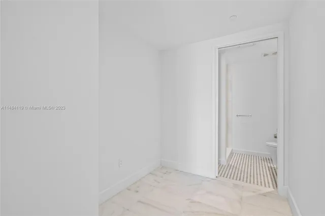 an empty room with sliding glass door and shower