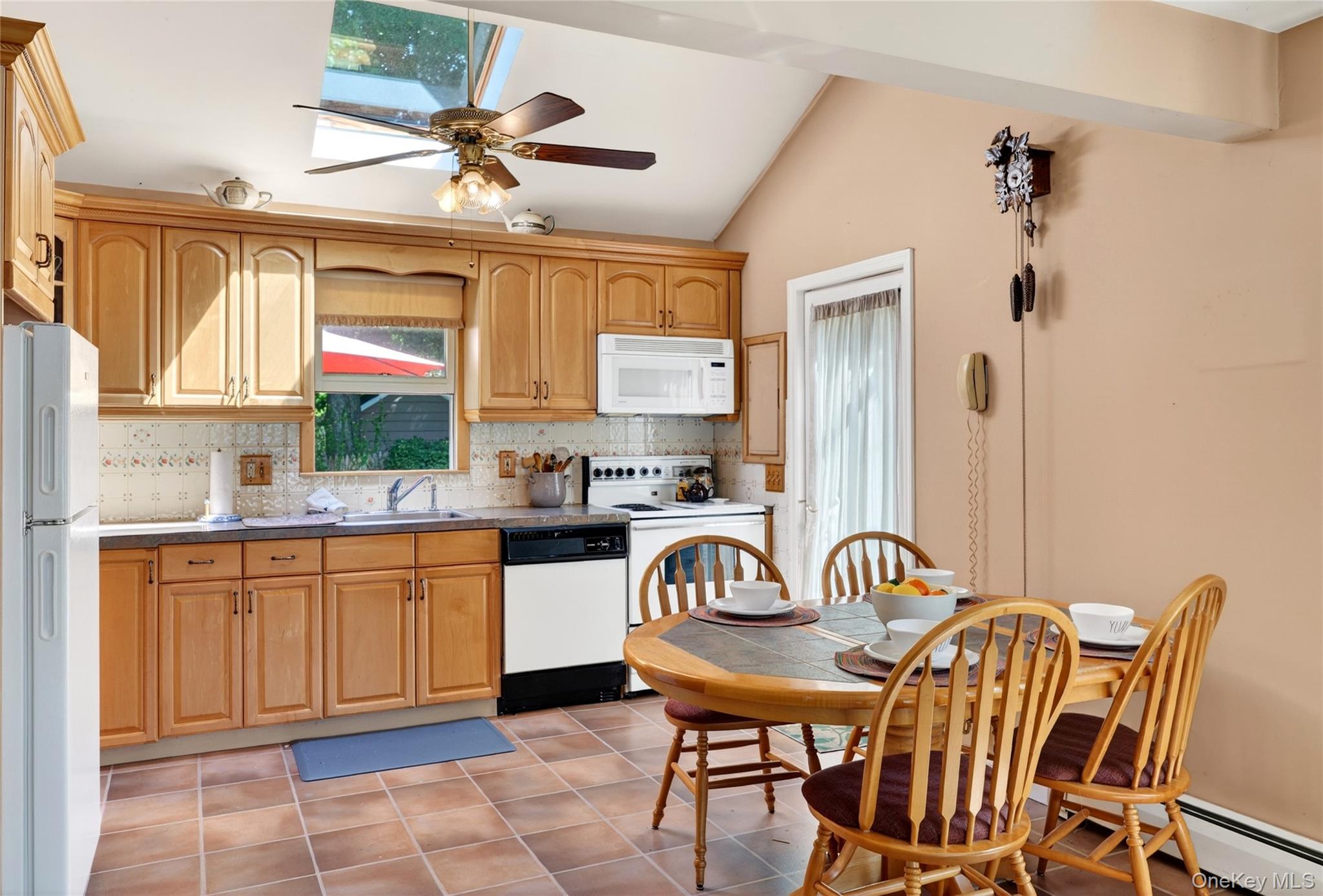 232 Cherry Road Yorktown Heights, NY 10598 - Photo 7 of 21 a kitchen with stainless steel appliances a table chairs and a window