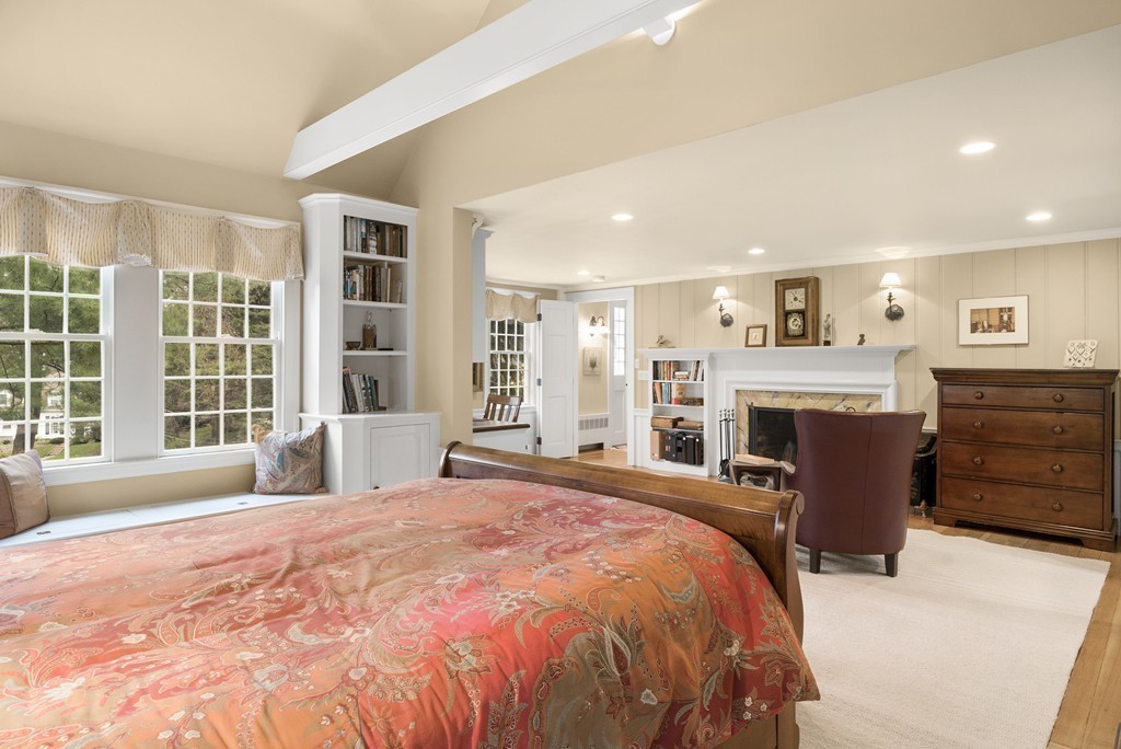 32 Cunningham Road Wellesley, MA 02481 - Photo 15 of 30 a spacious bedroom with a large bed and a fireplace