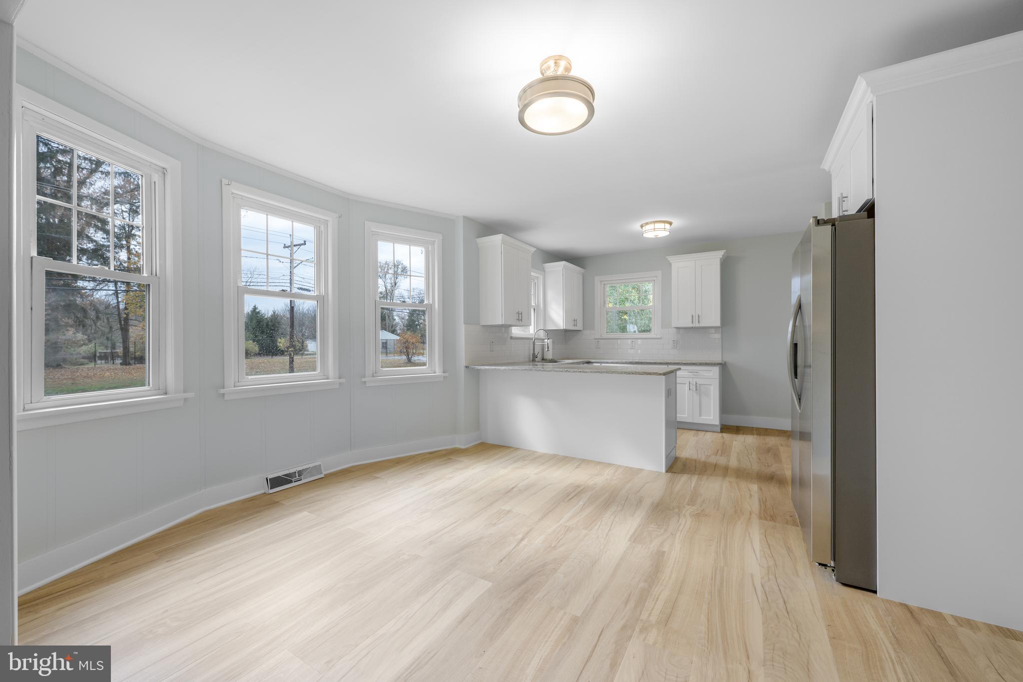 107 Hartford Road Mount Laurel, NJ 08054 - Photo 6 of 29 a view of large kitchen with wooden floor and windows