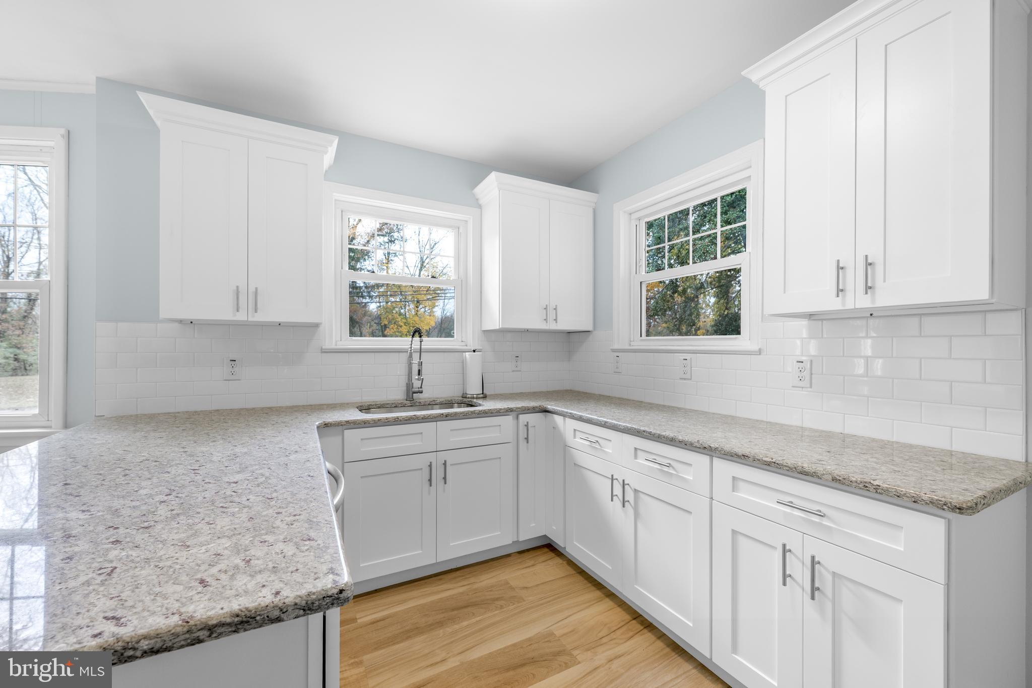 107 Hartford Road Mount Laurel, NJ 08054 - Photo 7 of 29 a kitchen with granite countertop white cabinets and window