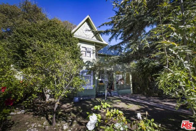 a view of a house with a yard and tree s