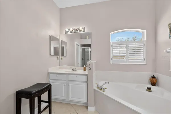 a en suite bathroom with a sink a mirror and a shower