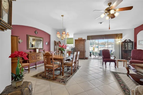 a living room with furniture a table and a chandelier