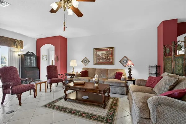 a living room with furniture a rug and a window