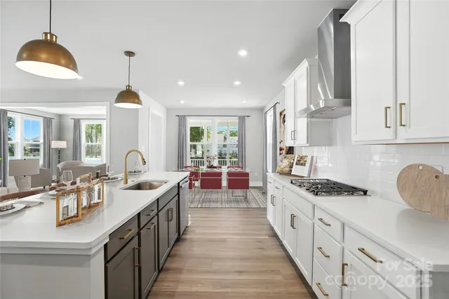 a kitchen with sink stove and cabinets