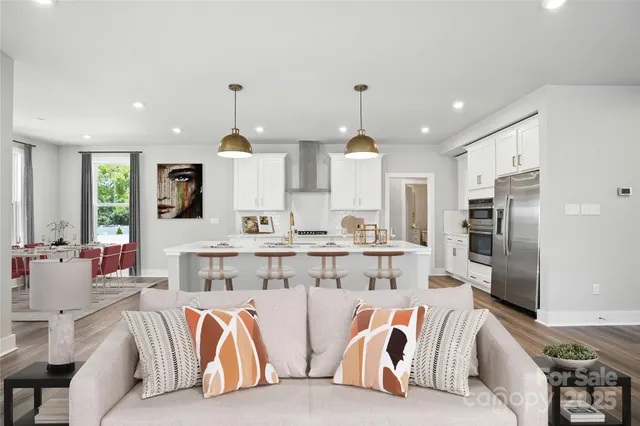 a living room with stainless steel appliances kitchen island granite countertop furniture a sink and a view of kitchen