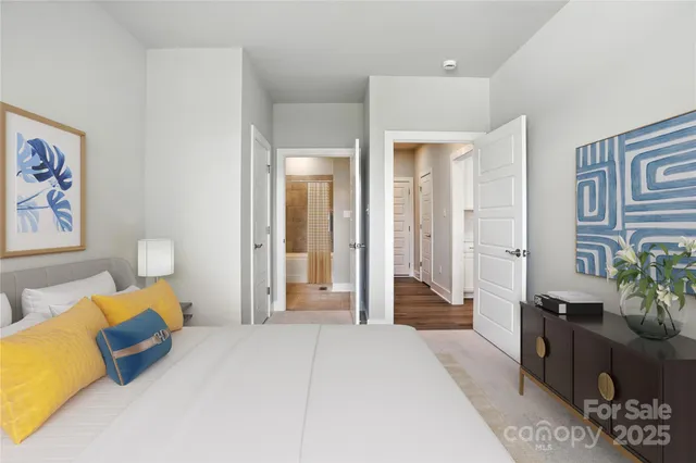 a bedroom with furniture and a potted plant