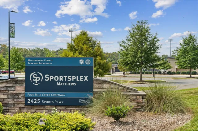 a view of swimming pool with a yard and plants