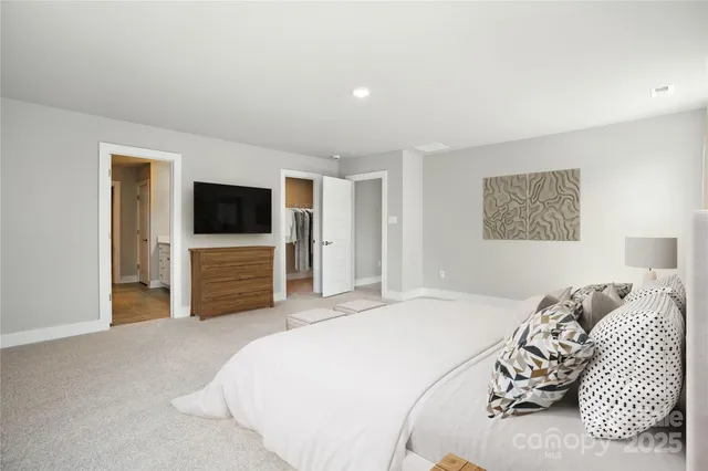 a bedroom with a bed and a television