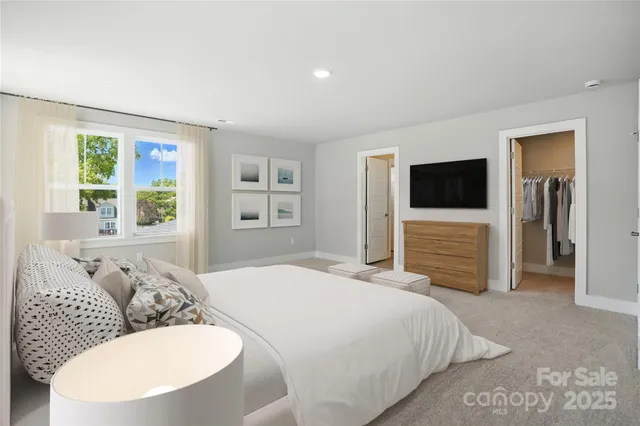 a bedroom with a bed and a television