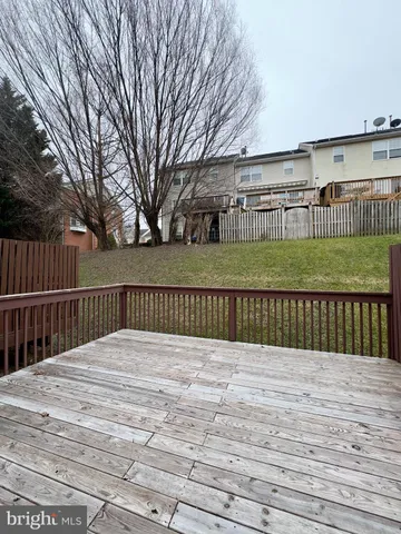 a view of empty room with wooden floor and entryway