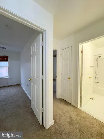 an empty room with a ceiling fan and window