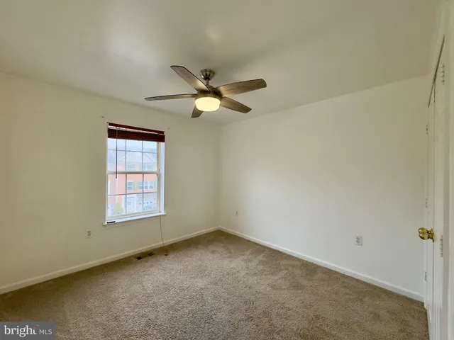 an empty room with a empty space and windows