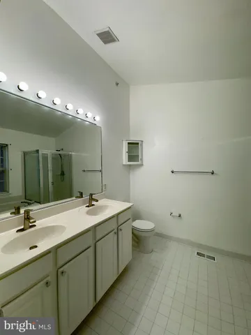 a bathroom with a tub a mirror and a shower