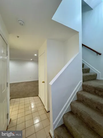 a bathroom with a granite countertop toilet and a sink