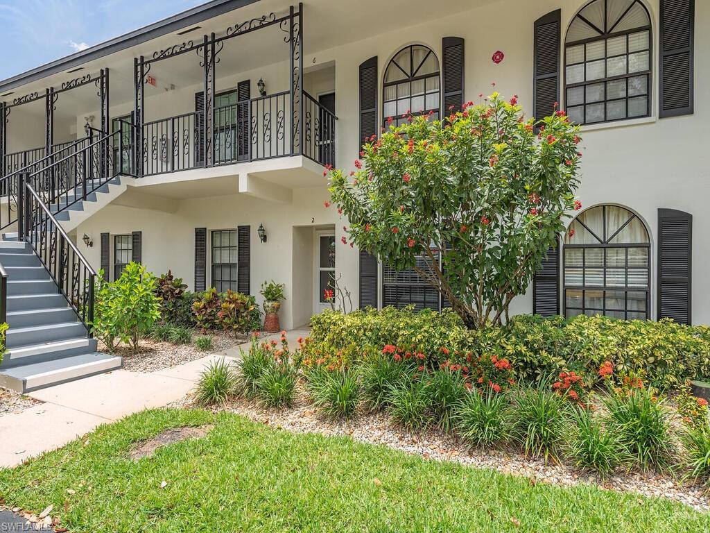 809 Augusta Boulevard, Unit 8092 Naples, FL 34113 - Photo 1 of 12 a front view of a house with a garden