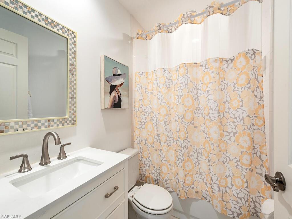 809 Augusta Boulevard, Unit 8092 Naples, FL 34113 - Photo 11 of 12 a bathroom with a sink toilet and shower