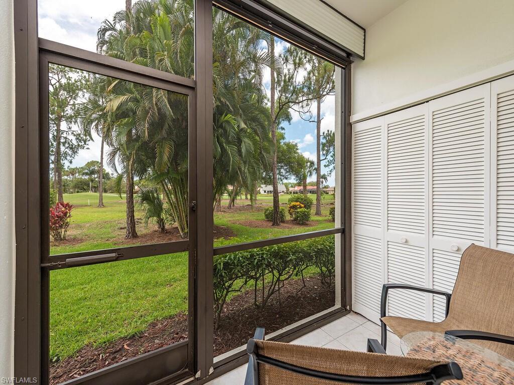 809 Augusta Boulevard, Unit 8092 Naples, FL 34113 - Photo 2 of 12 a view of a floor to ceiling window and a porch