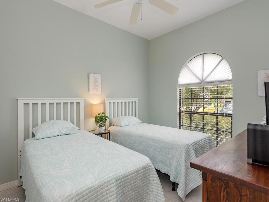 809 Augusta Boulevard, Unit 8092 Naples, FL 34113 - Photo 10 of 12 a bedroom with two beds and a window