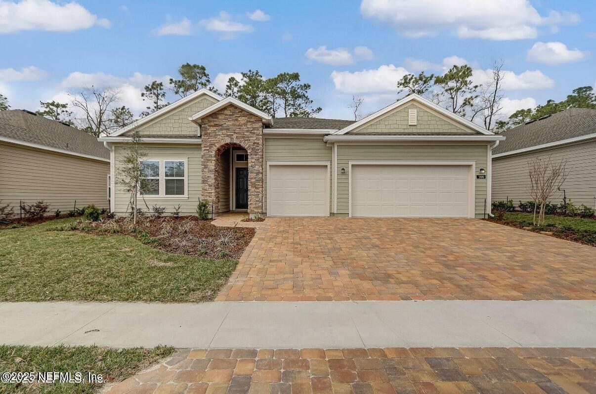 a view of a house with a yard and potted plants