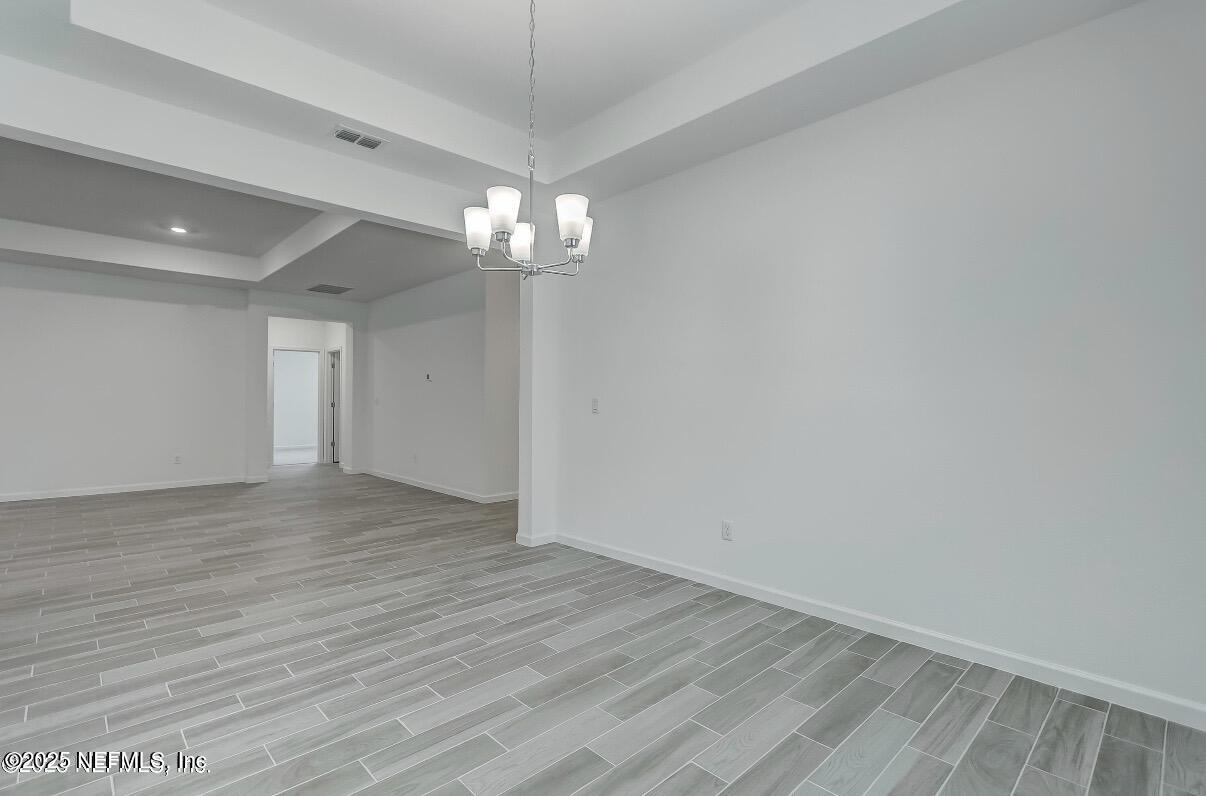 300 Gan Way St. Johns, FL 32259 - Photo 19 of 36 a view of empty room with wooden floor and chandelier