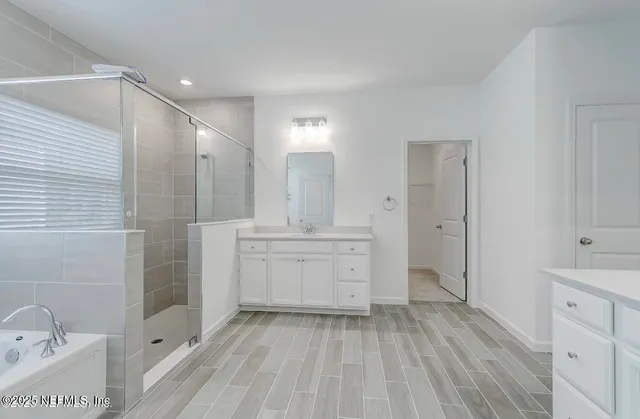 a bathroom with a sink a mirror and a bathtub