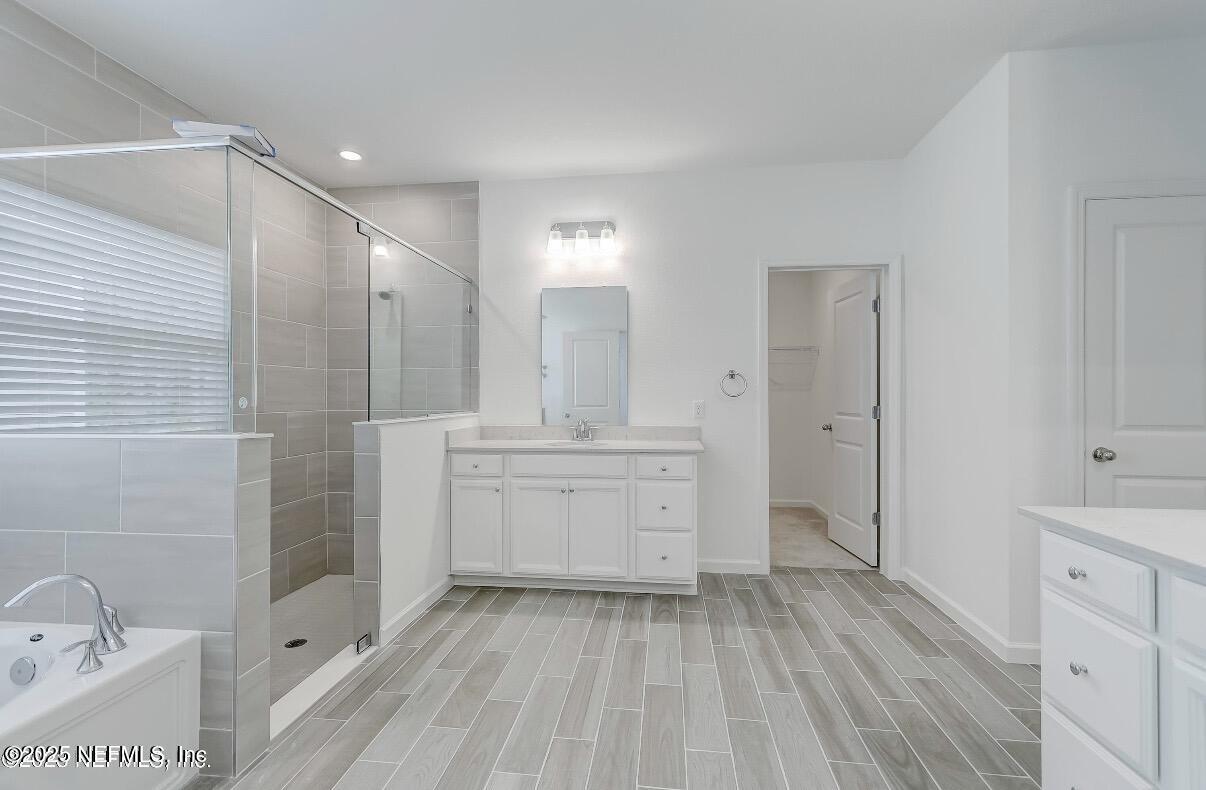 300 Gan Way St. Johns, FL 32259 - Photo 24 of 36 a bathroom with a sink a mirror and a bathtub