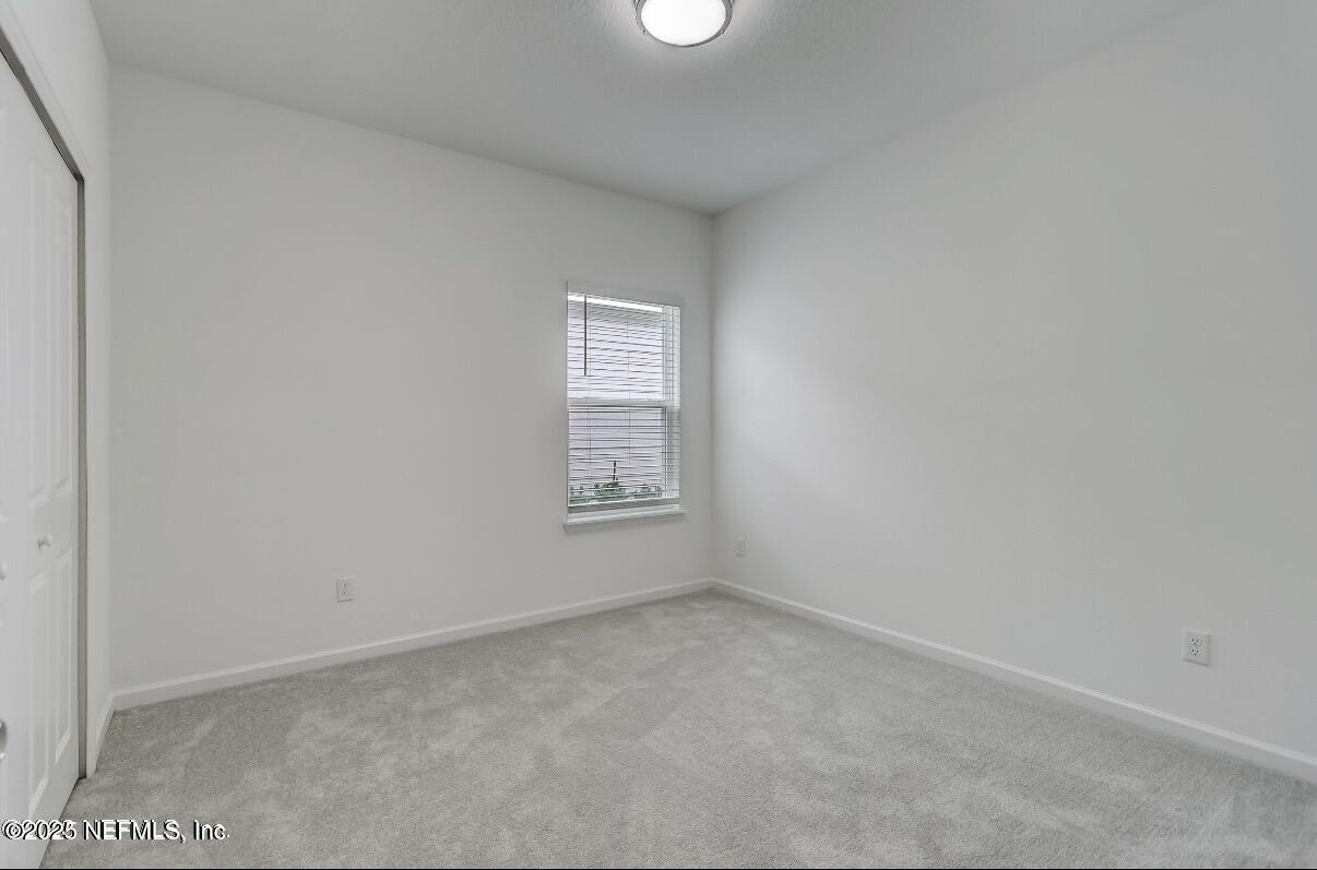 300 Gan Way St. Johns, FL 32259 - Photo 32 of 36 an empty room with a window