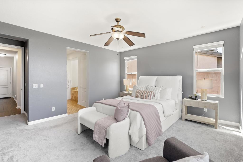 1407 Eclipse Drive San Marcos, CA 92078 - Photo 14 of 32 a bedroom with a bed and a chandelier